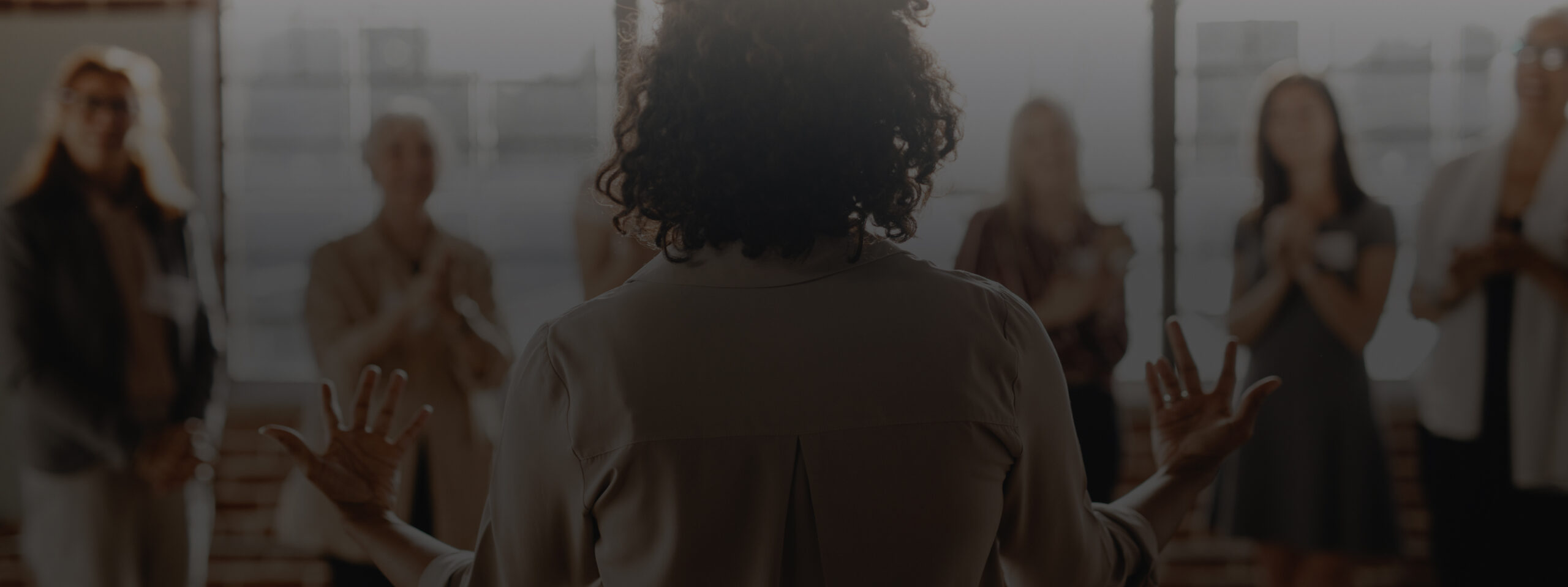 Girl standing in front of group of people