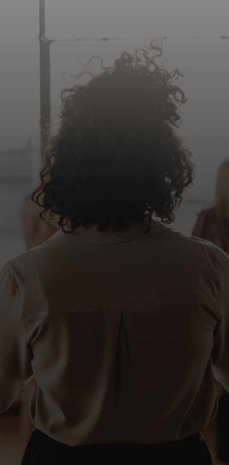 Girl standing in front of group of people