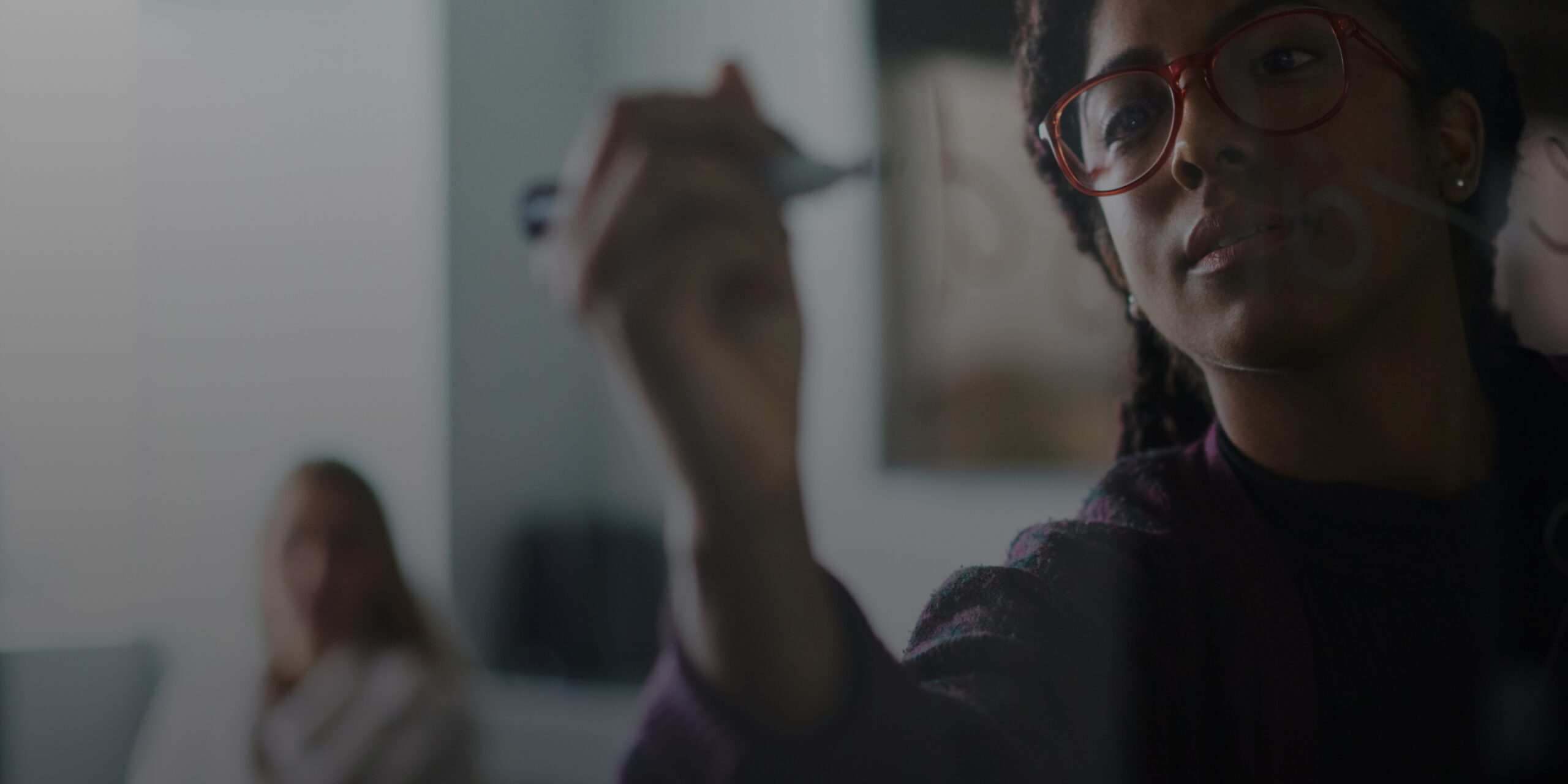 Girl writing on glass wall