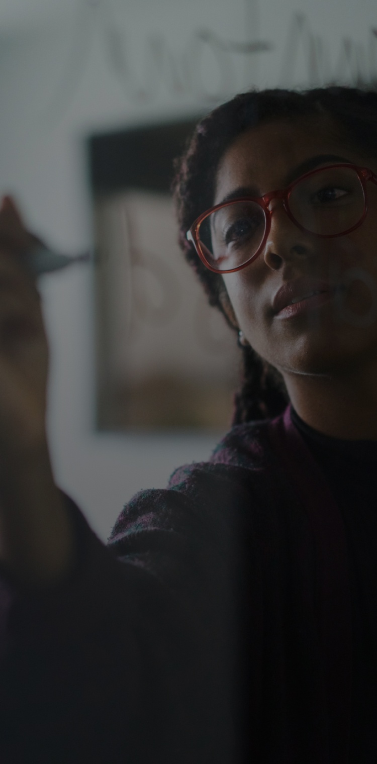 Girl writing on glass wall