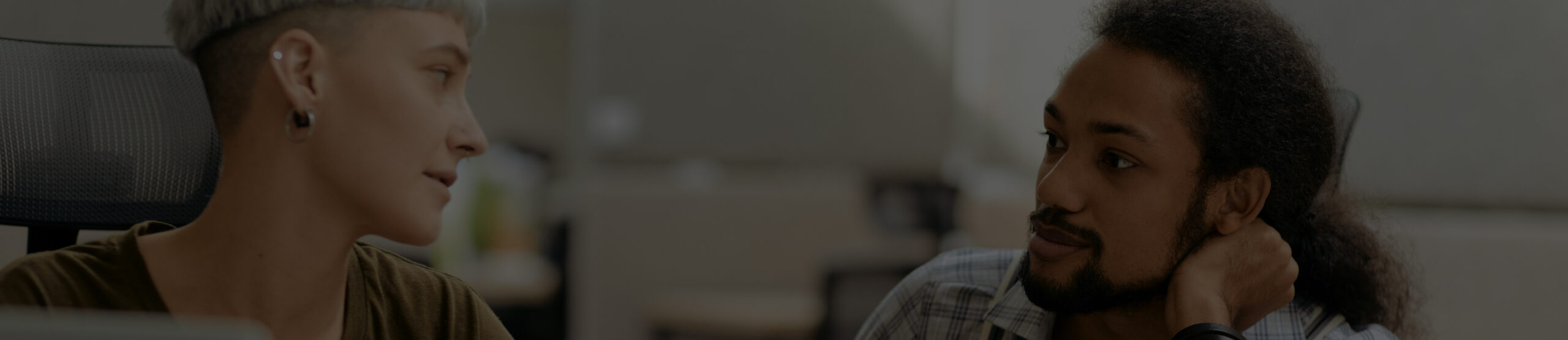 Man and woman talking to each other in office