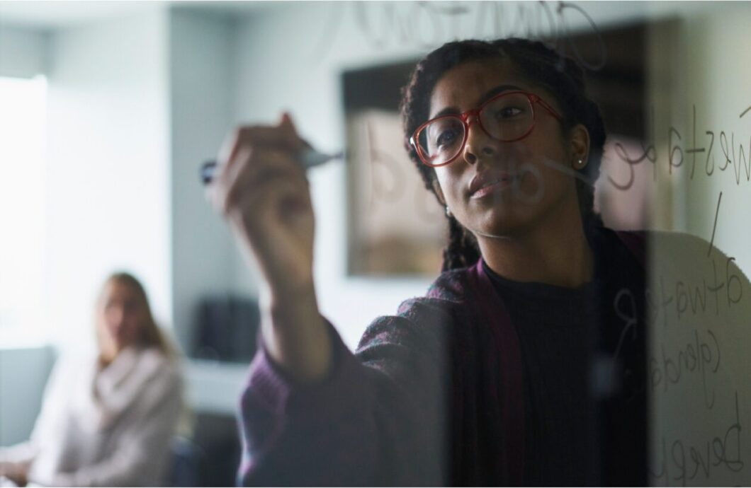 Girl writing on glass wall