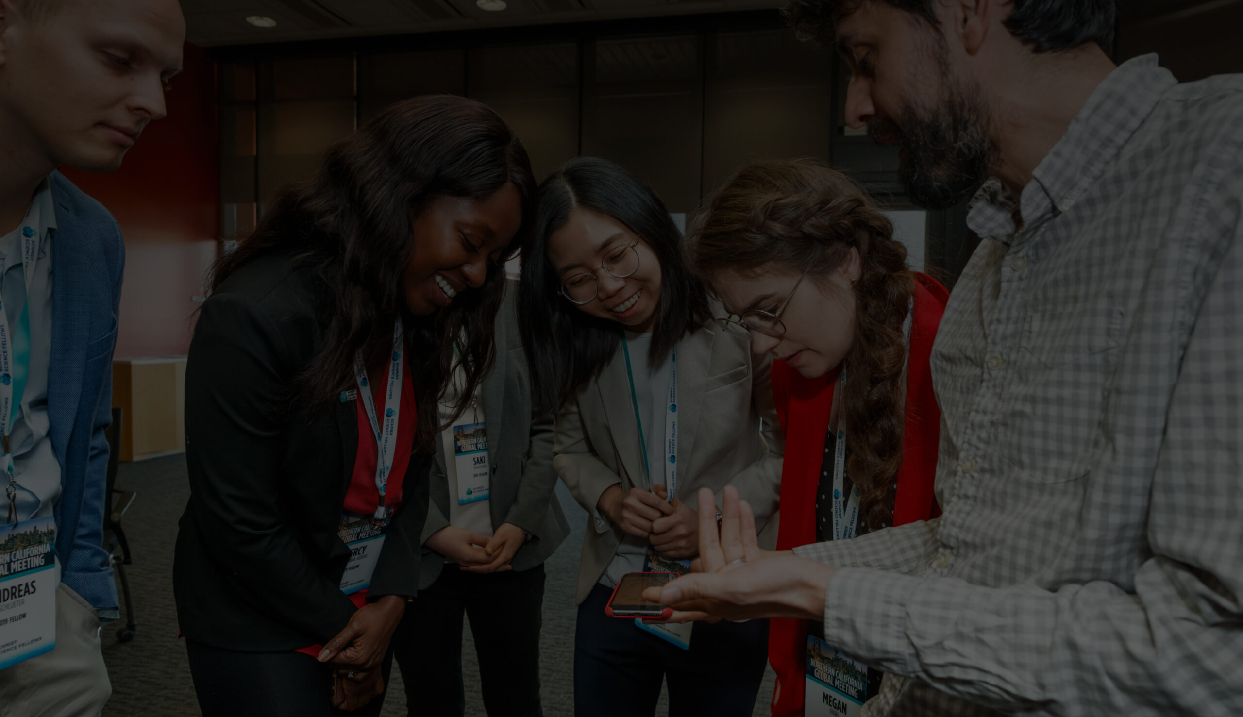 Group of people gathered around a phone